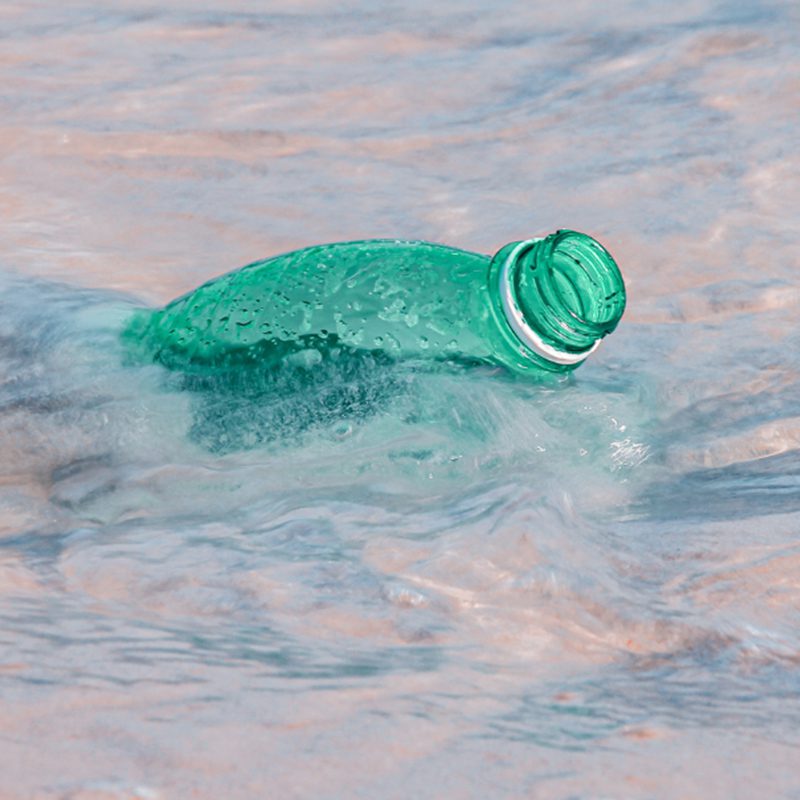 plastic water bottle floating in ocean