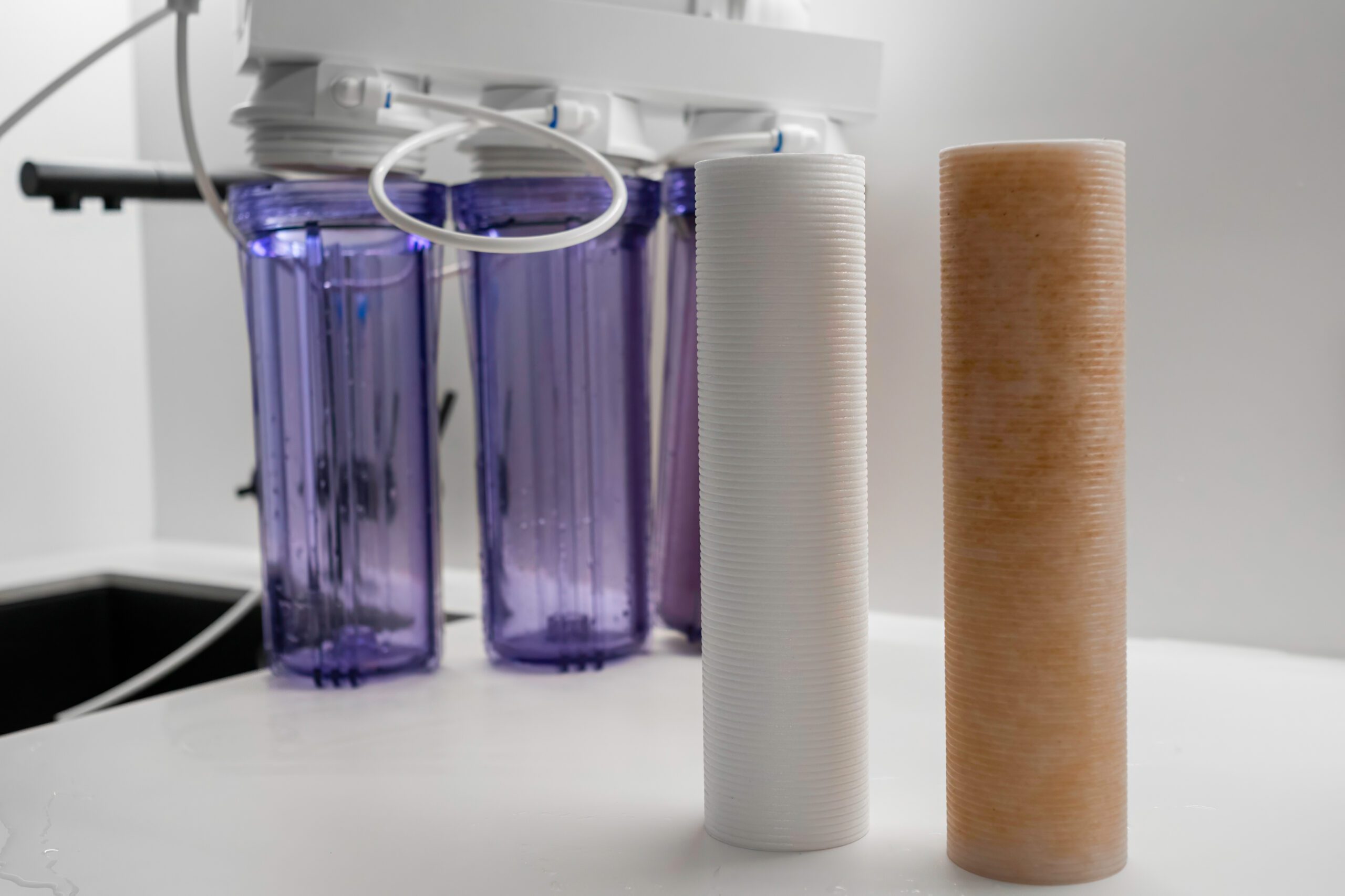 Dirty and clean filters for reverse osmosis on the table in the modern kitchen Dirty and clean filters for reverse osmosis, in modern kitchen